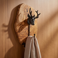 Olive wood wall plaque with a cast iron stag head and coat hook